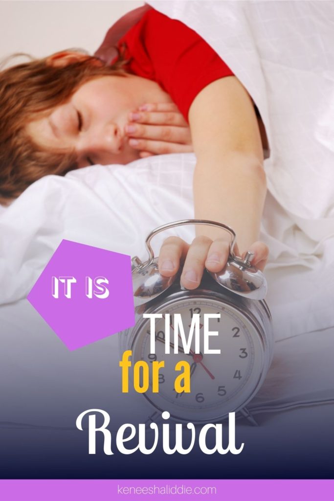 It is time for revival: An alarm clock with a woman lying in bed in the background